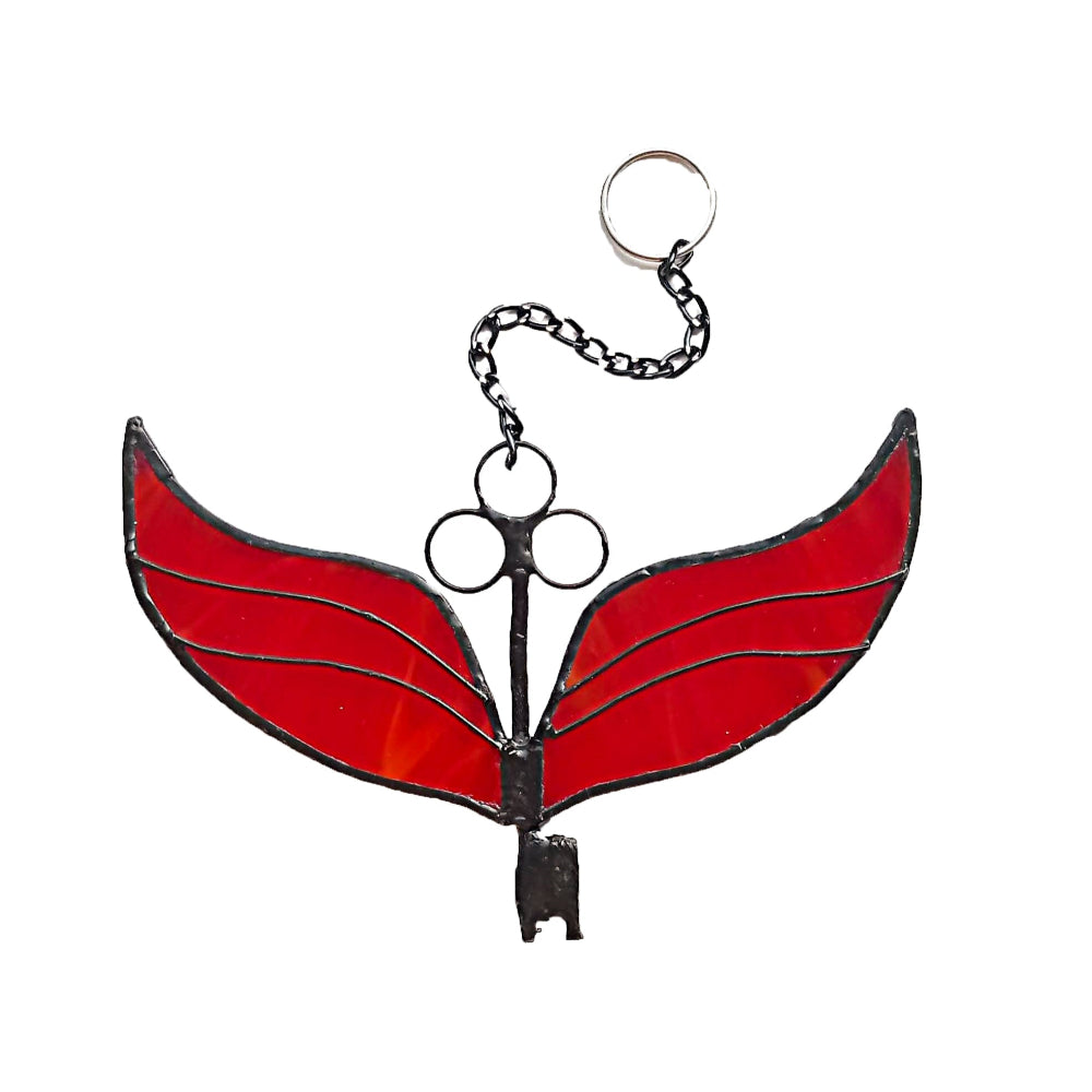Red stained glass key-shaped ornament on a white background