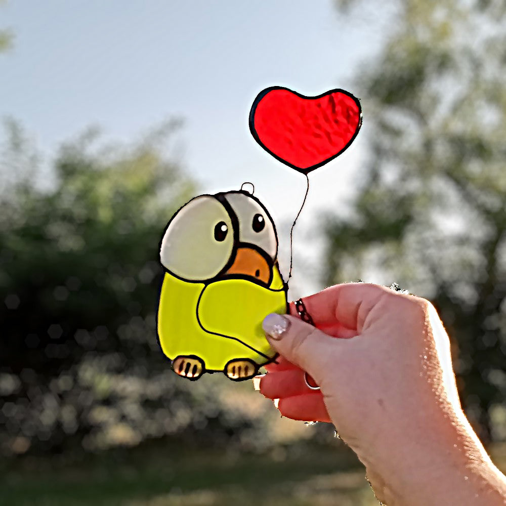 Chick stained glass with heart balloon
