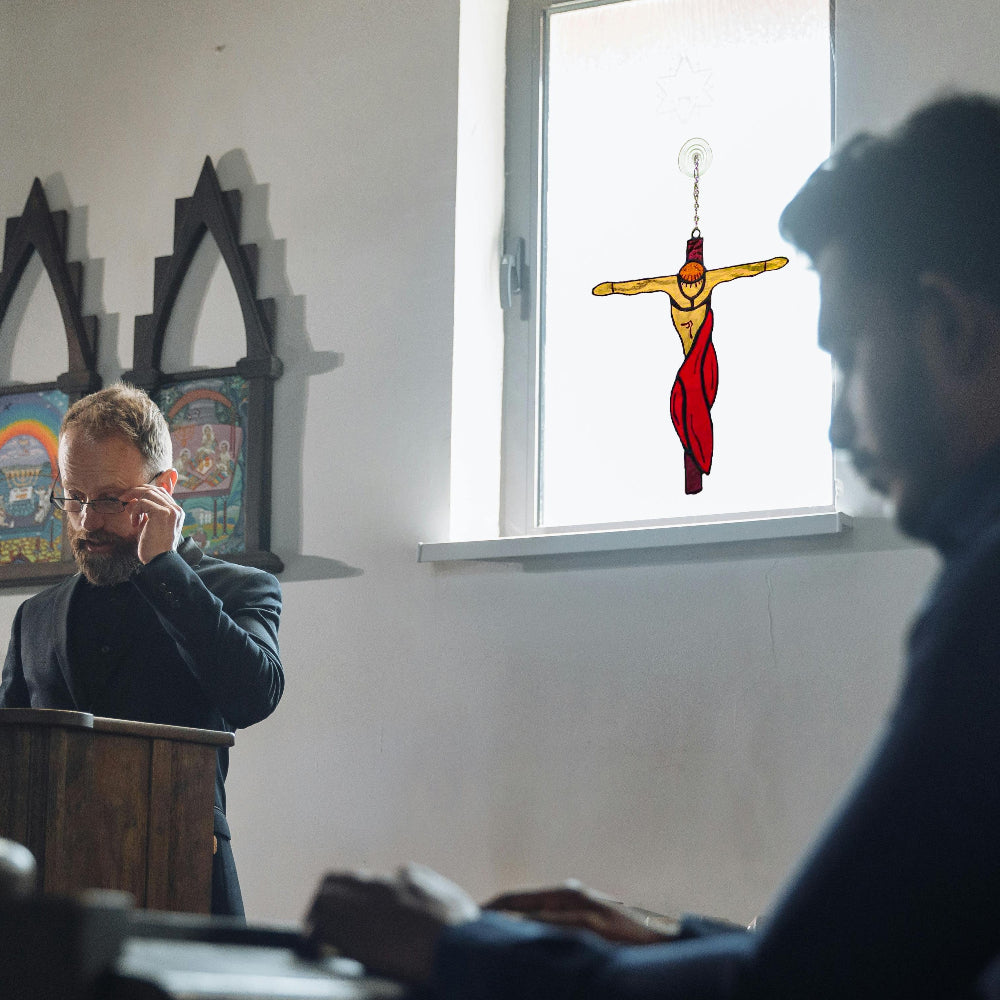 Stained glass crucifixion suncatcher hang on church window